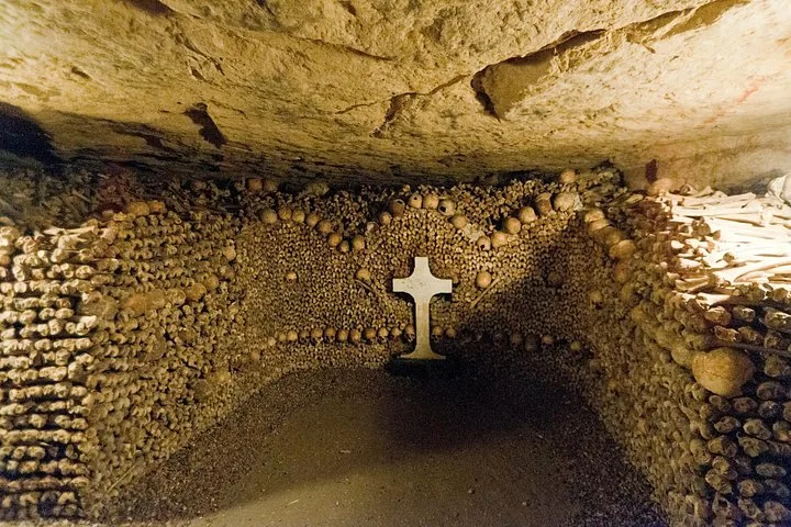 Una formazione a croce costruita con teschi circondata da altre ossa nelle Catacombe.